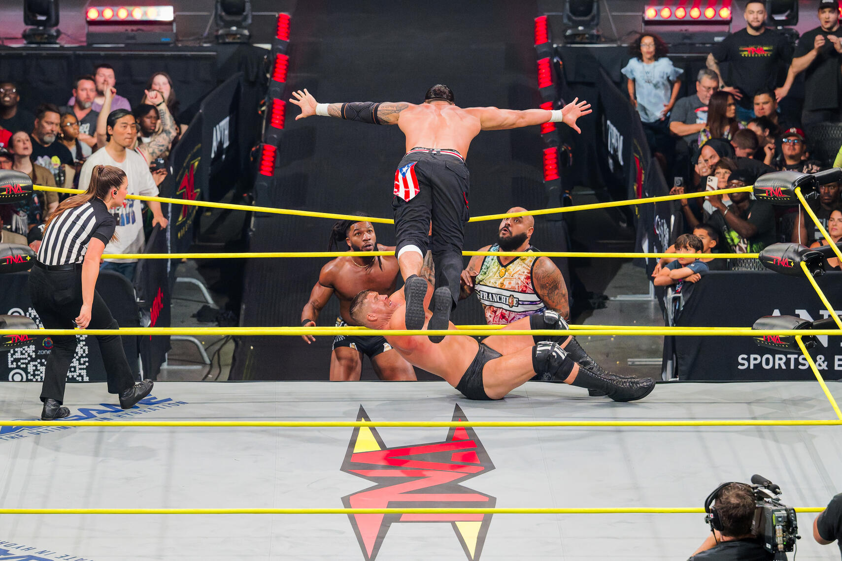 BALTIMORE, MD - Mike Santana dives over the top rope during the August 16, 2025 TNA Impact event at Chesapeake Employers Insurance Arena in Baltimore, Maryland.